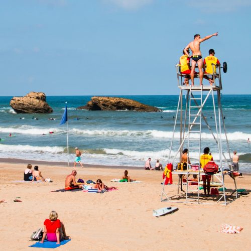 a group of people on a lifeguard tower at a beach