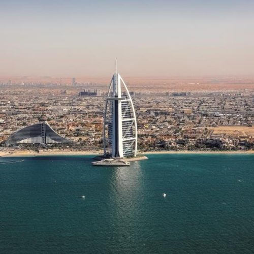 a tall building in the middle of a body of water